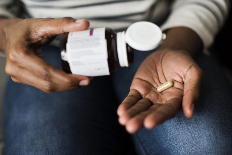 person holding collagen supplements Powder or Pills? Choosing the Best Collagen Supplement for You
