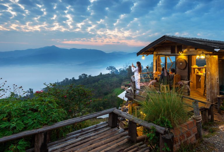woman taking photo morning mist phu lang ka phayao thailand 1 1 1290x878 1 Reasons to Stay at Dandeli Resort: An Unforgettable Jungle Getaway