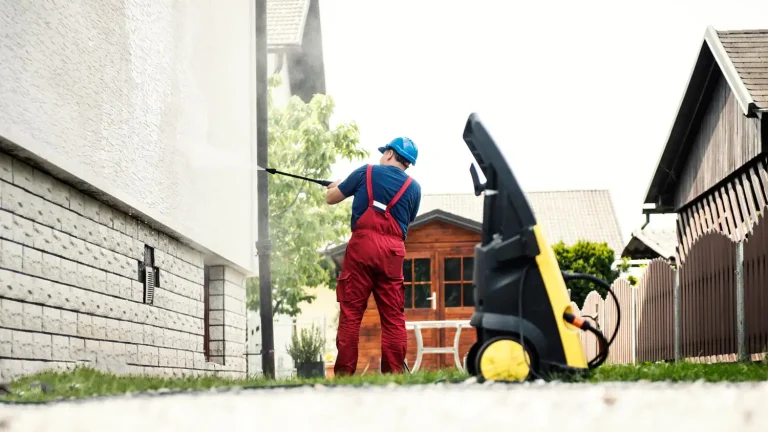 man power washing house exterior 957382554 The Essential Guide to Keeping Your Home Exterior Sparkling Clean