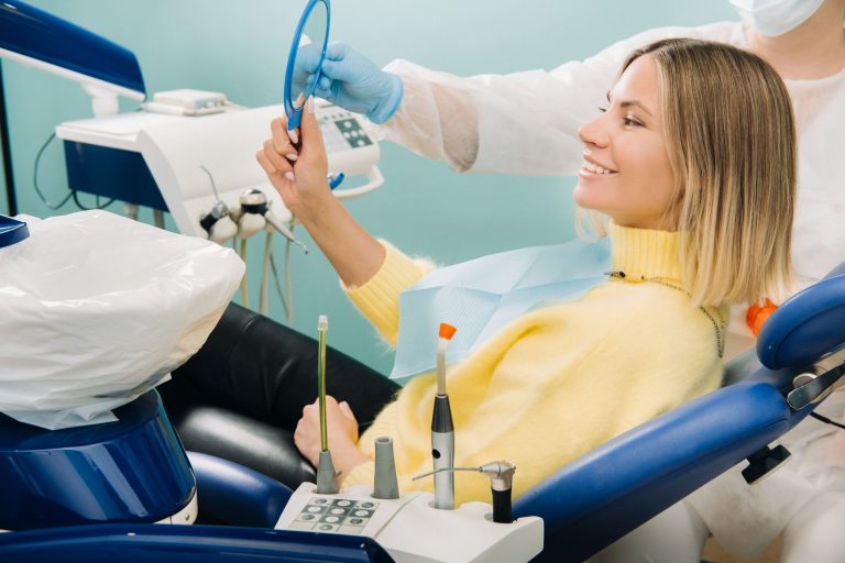 the girl smiles and looks in the mirror in dentist 2021 09 04 02 40 39 utc min scaled 1 Cosmetic Dentistry Dental Courses: A Growing Trend