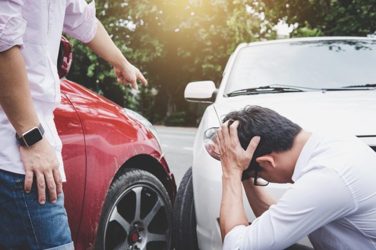 two men arguing after a car accident To Court or Not to Court? Decoding the Settlement Dilemma After a Car Accident