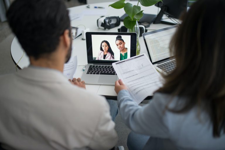two people on a virtual meeting on pc Exploring Must-Have Features in Modern Virtual Office Platform