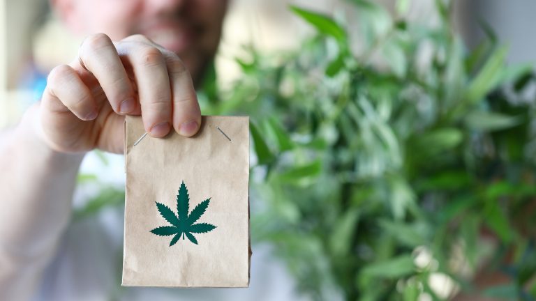 closeup small paperbag marijuana leave on it 1212246649 Shop the Best Cannabis Products at Licensed Dispensaries