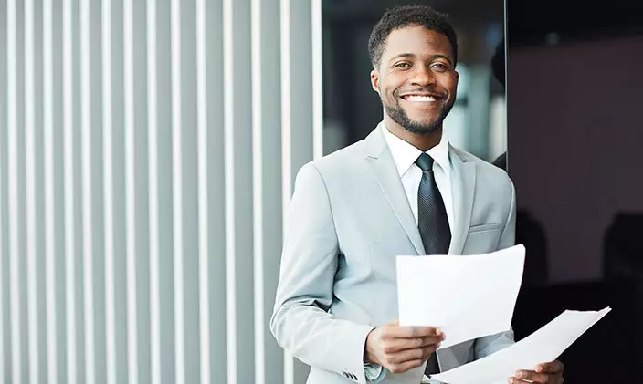 african american male business analyst holding business Starting a Career as a Business Analyst in the USA