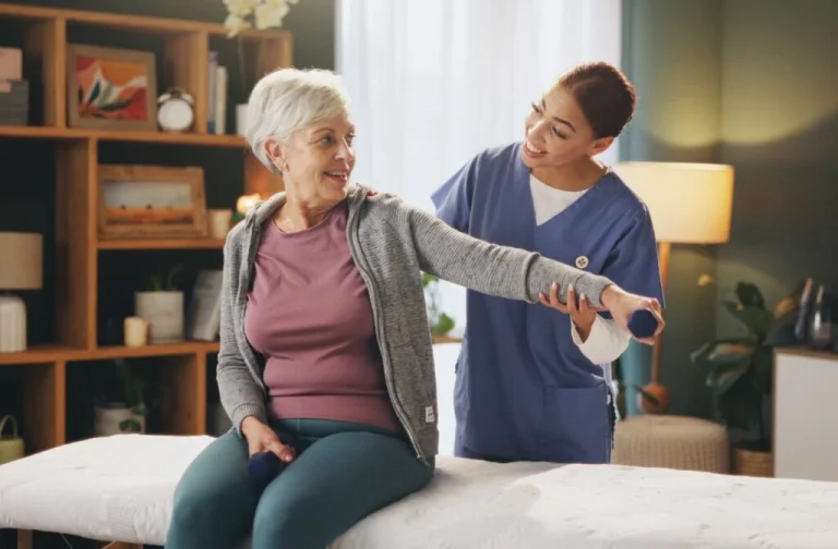 caregiver and senior patient with dumbbells for rehabilitation showcasing importance of physical wel 1024x672 1 Senior Living Services: Comfort, Care, and Wellness Programs