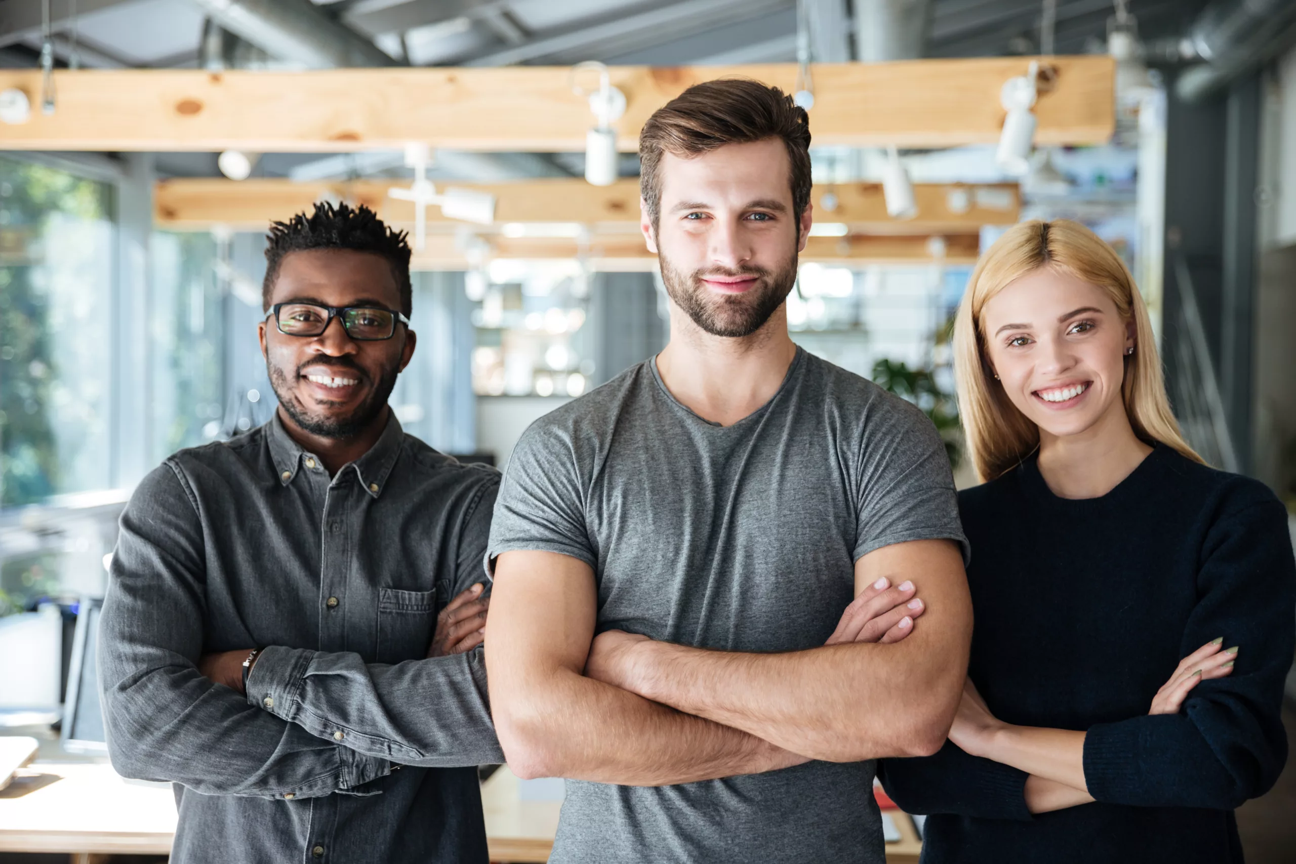 smiling young colleagues standing with arms crossed scaled 1 Knowing Where Your Company Stands Today