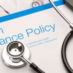 health insurance policy booklet and stethescope What is a Health Insurance Policy? Features & Benefits Explained