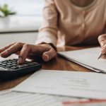 woman calculator budget finances SOMN19162 869247602 is 1560x880 Knowing What Your Real Living Expenses Are